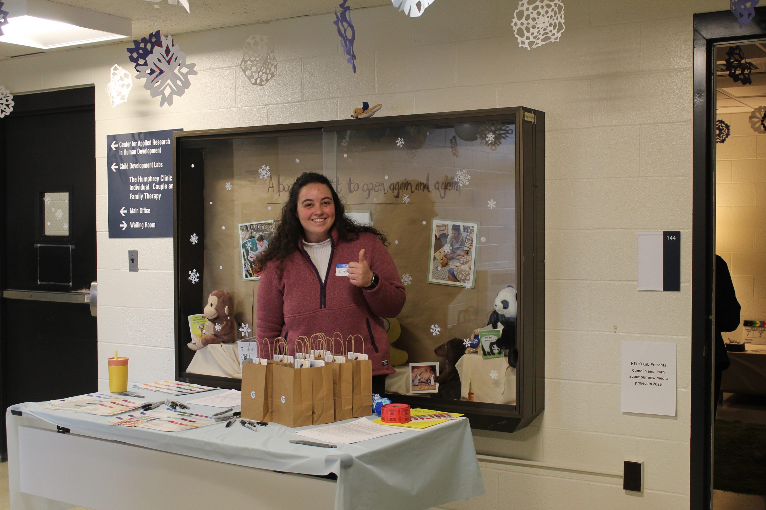 Woman stands at reception table for Winter Wonderland 2024.