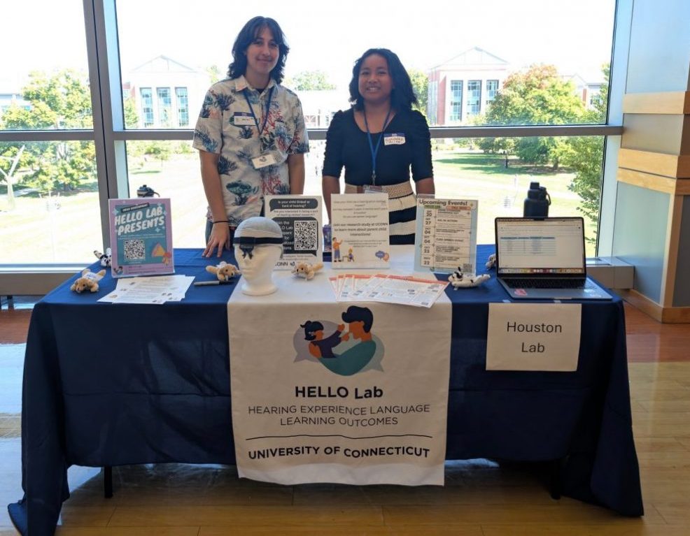 B. and Narindra smiling at the camera while tabling